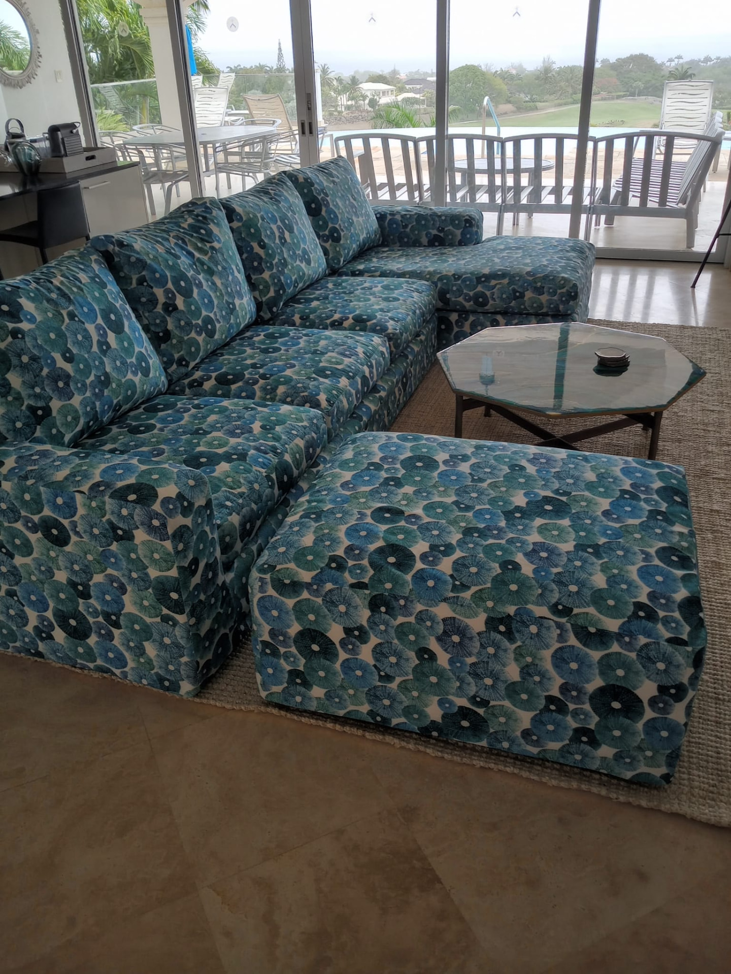 Sectional sofa and ottomans reupholstered in blue sea-urchin print fabric in a Barbados villa