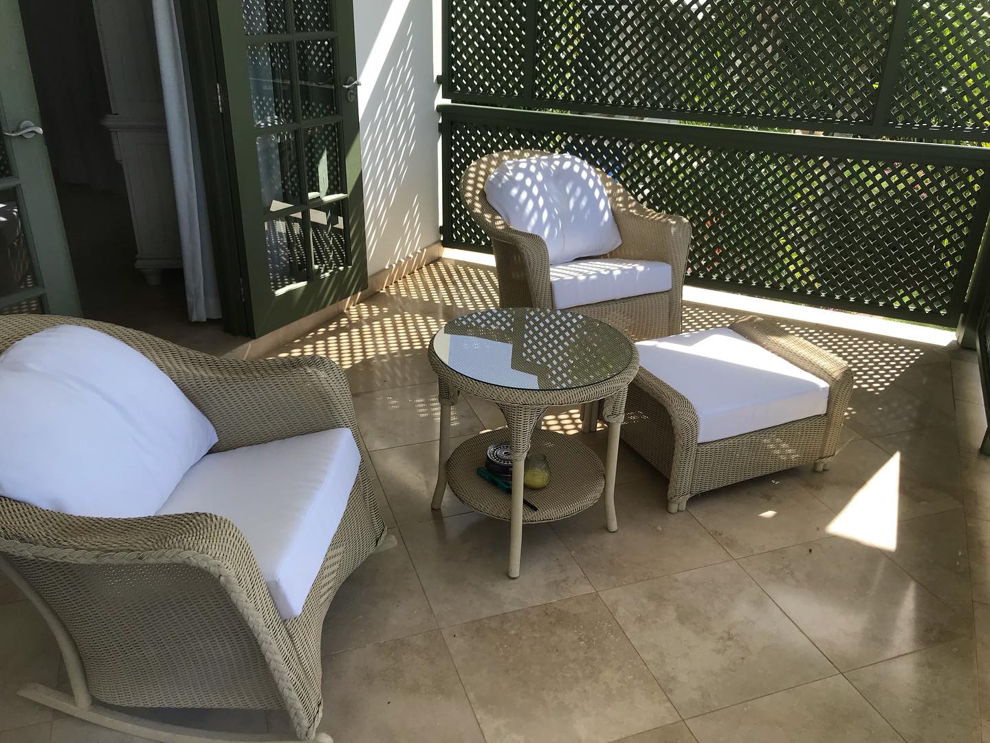 Wicker poolside furniture set with newly upholstered white outdoor cushions